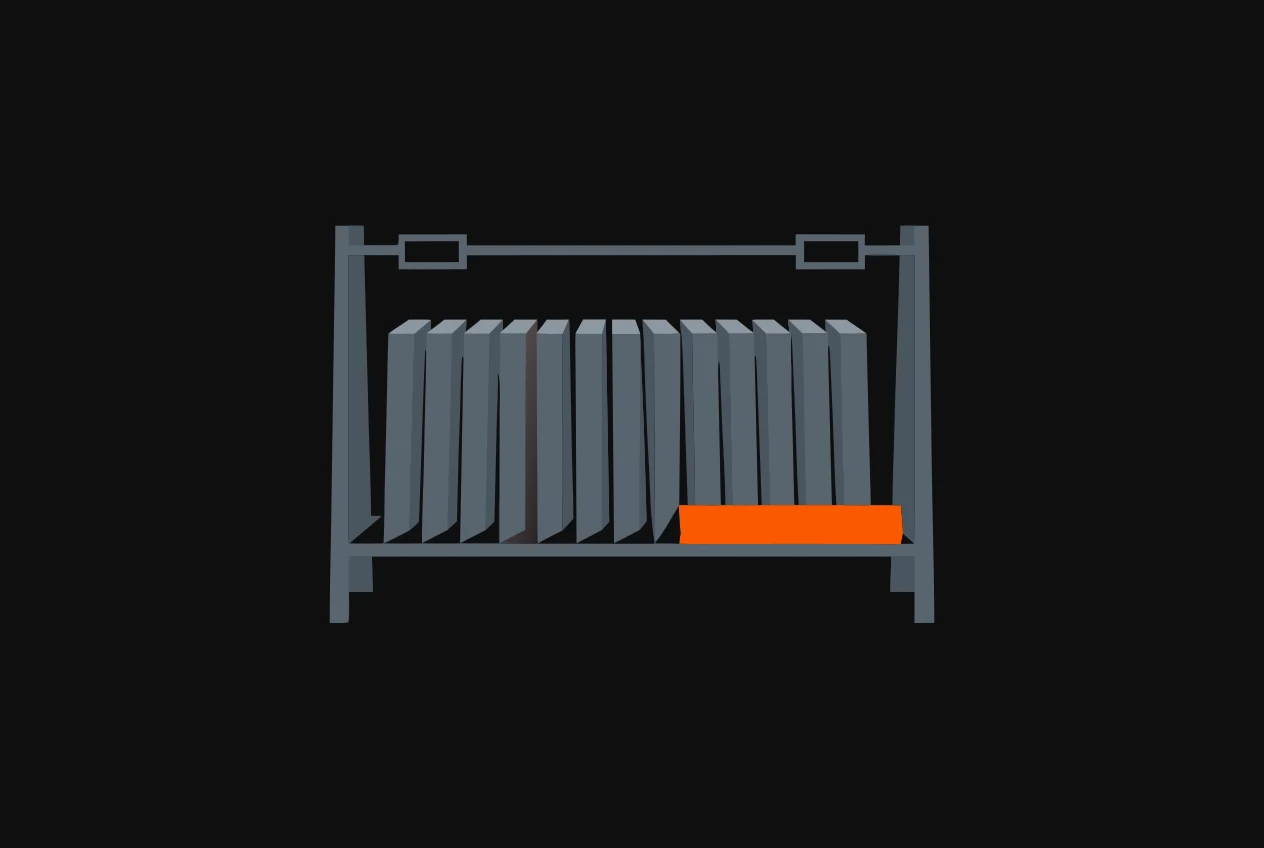 A rack of index cards with one card pushed down below the rest, only its orange top edge showing.